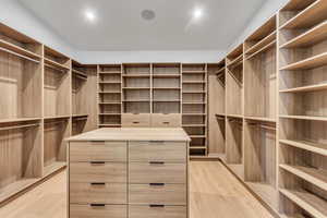 Walk in closet featuring light wood-style floors