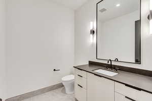 Half bathroom featuring vanity and recessed lighting