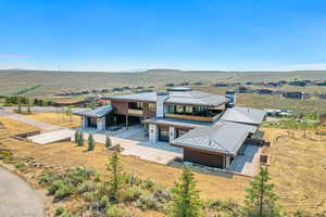Aerial view of property and surrounding area featuring a mountain backdrop