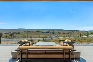 View of patio featuring a deck with mountain view and an outdoor hangout area