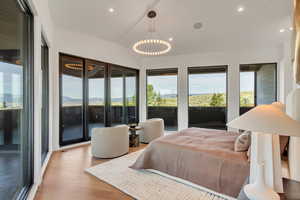 Bedroom featuring wood finished floors, recessed lighting, and access to outside