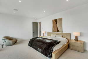 Carpeted bedroom featuring recessed lighting and baseboards