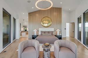 Bedroom with recessed lighting, wood finished floors, and an accent wall