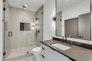 Full bathroom with vanity and a shower stall