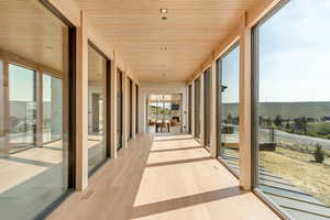 Unfurnished sunroom with wood finished floors and wood ceiling