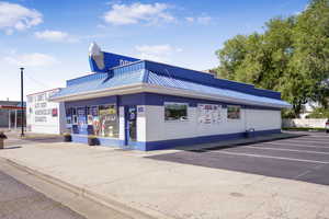 View of commercial property featuring uncovered parking