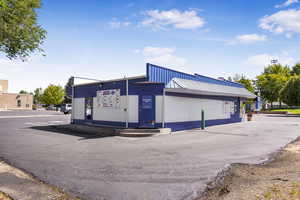 View of commercial property with uncovered parking