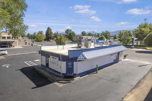 View of asphalt road with curbs and a mountain view