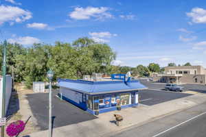 View of asphalt street with street lighting, curbs, and sidewalks