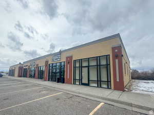 View of commercial location featuring uncovered parking