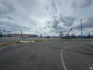 View of asphalt street featuring street lighting