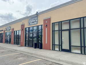 View of property featuring uncovered parking