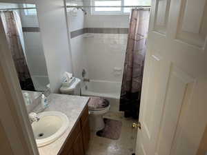 Bathroom with shower / tub combo and vanity