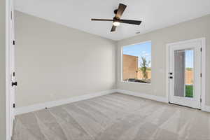 Unfurnished room featuring light carpet and ceiling fan