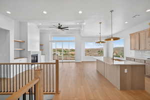Kitchen featuring open floor plan, plenty of natural light, decorative backsplash, light wood-type flooring, and recessed lighting