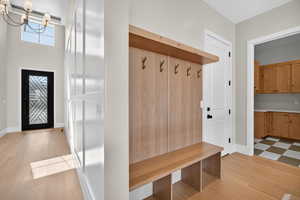 Mudroom featuring light wood-style floors and baseboards