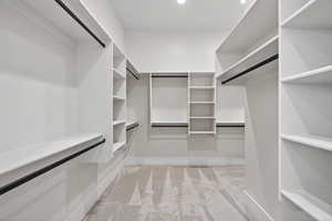 Spacious closet with light colored carpet