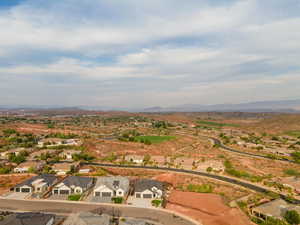 Aerial view of property's location with nearby suburban area and mountains