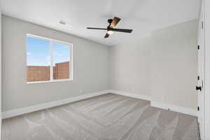 Empty room with light carpet and ceiling fan