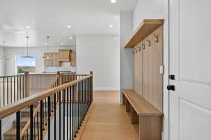Mudroom with light wood-style floors and recessed lighting