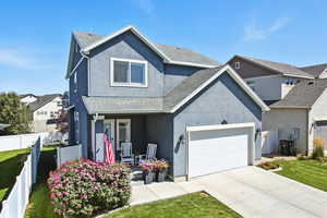 Traditional-style house featuring a porch, stucco siding, concrete driveway, and a shingled roof