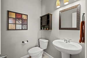 Bathroom featuring toilet and baseboards
