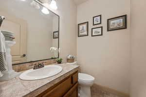Half bathroom featuring vanity and tile patterned flooring