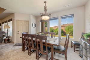 Dining space featuring baseboards and light tile patterned floors
