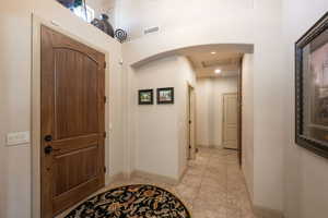Foyer with baseboards and light tile patterned flooring