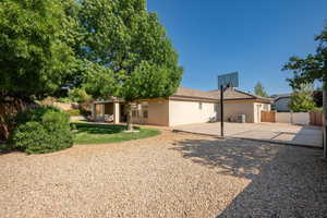 Rear view of house featuring a patio, stucco siding, and a tile roof