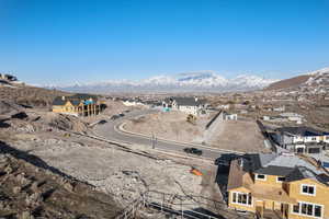 Aerial overview of property's location featuring mountains and nearby suburban area