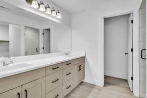 Full bath featuring a stall shower and light wood-style floors