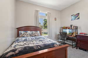 Large Bedroom with carpet and a desk