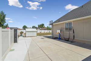 Fenced backyard with a patio area and a storage shed