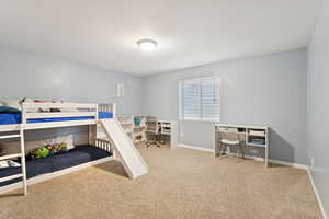 Bedroom with carpet and an office area