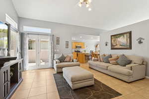 Living area with light tile patterned floors and ceiling fan
