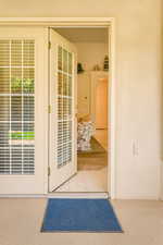 Doorway to outside with arched walkways and tile patterned flooring