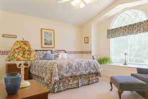 Bedroom with carpet, lofted ceiling, and ceiling fan