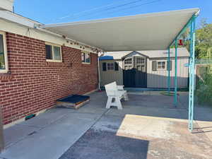 View of patio / terrace featuring a storage unit