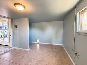Additional living space with light tile patterned flooring and french doors