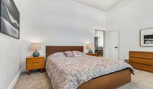 Bedroom featuring light carpet and high vaulted ceiling