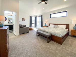 Bedroom featuring vaulted ceiling, light carpet, a ceiling fan, recessed lighting, and ensuite bath