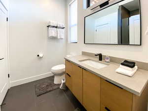Bathroom with vanity and dark tile patterned flooring