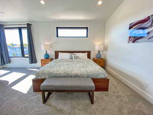 Carpeted bedroom with recessed lighting and baseboards
