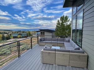 Wooden terrace with an outdoor living space and a residential view