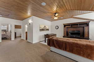 Carpeted bedroom featuring wooden ceiling and ceiling fan