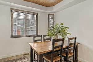 Dining area with wood ceiling and a tray ceiling