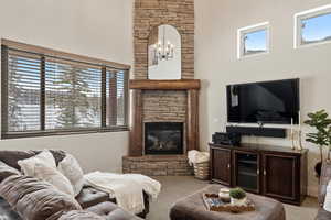 Carpeted living room featuring a fireplace