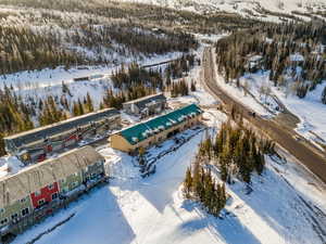 Snowy aerial view with a forest view