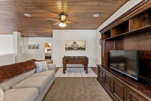 Living area with wooden ceiling and ceiling fan